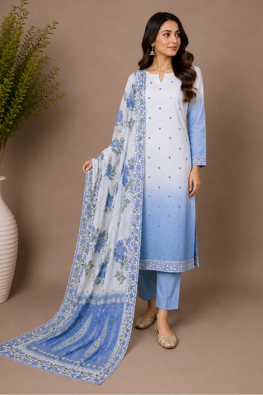 Woman wearing a blue and white traditional outfit with a matching dupatta against a brown background