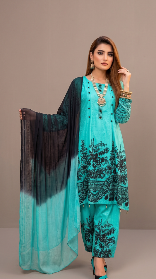 Woman wearing a turquoise traditional outfit with black patterns on a beige background