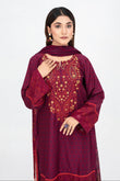 Woman wearing a maroon embroidered traditional outfit on a white background