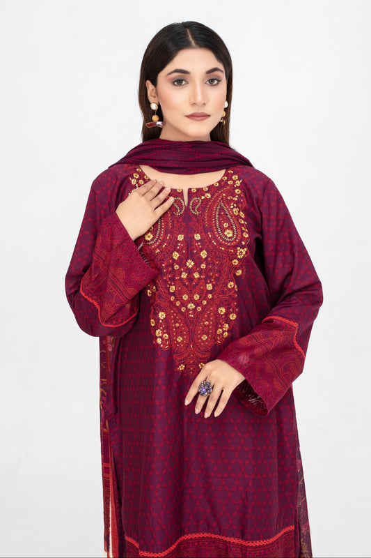 Woman wearing a maroon embroidered traditional outfit on a white background