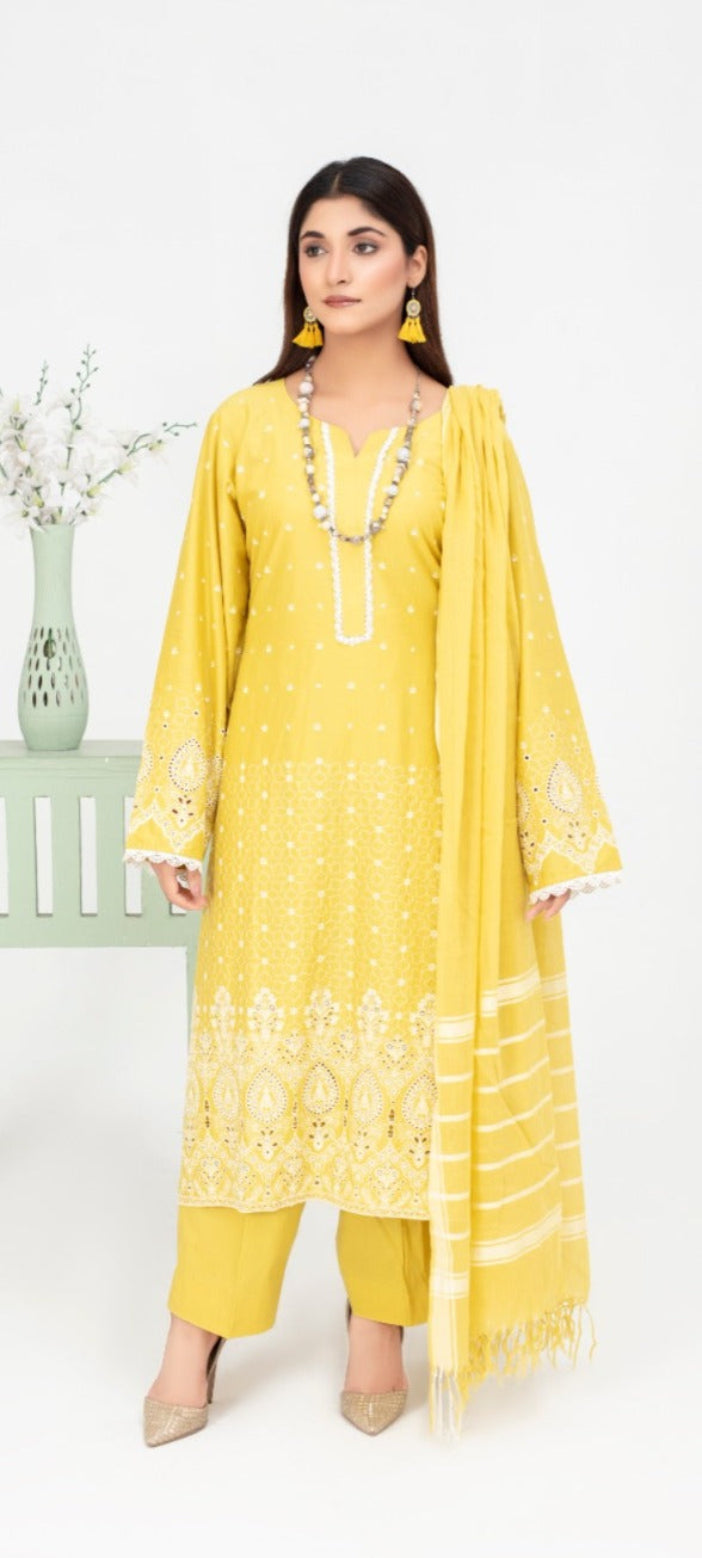 Woman wearing a yellow embroidered outfit with a white background